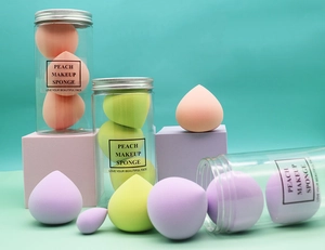 Macro view of macaron peach makeup sponges displayed on geometric studio props
