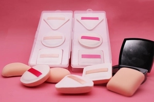 Macro view of multi-shaped soft Rubycell makeup sponges in a clear storage box
