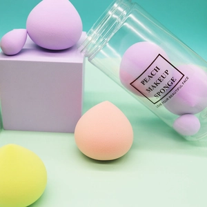 Colorful peach makeup sponge set in clear jar packaging with pink yellow and purple sponges