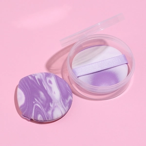 Set of two purple marble makeup puffs with round transparent storage case on pink background