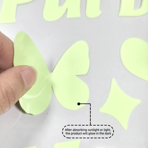 Detail of peeling a glow-in-the-dark butterfly sticker set for home wall decoration