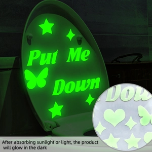Luminous green stickers with butterflies and heart patterns glowing in a dark bathroom