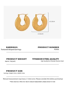 Detailed view of striped golden hoop earrings made of titanium steel with ribbed texture