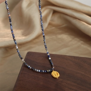 Handmade natural stone beaded necklace with a golden vintage oval medallion pendant