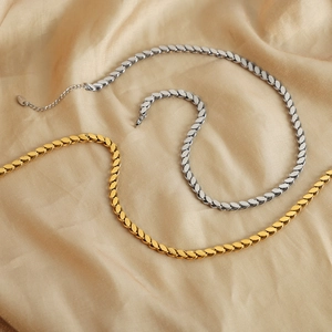 Flat scale chain necklaces in gold and silver finish on silk background
