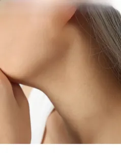 Detailed view of silver hoop earrings with ribbed texture worn by a model in profile
