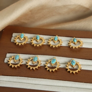 Bohemian sun-shaped titanium steel earrings with turquoise inlays in a display box