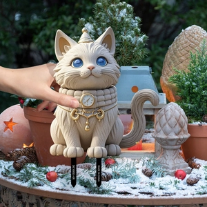 Cat garden stake with stone texture and blue eyes standing in a snowy winter landscape
