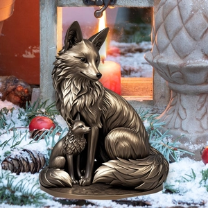 Close-up of bronze fox mother and cub statue with detailed fur texture in snow scene