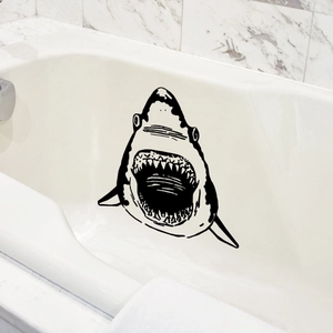 Cartoon black shark wall sticker decal applied to white bathtub in modern bathroom