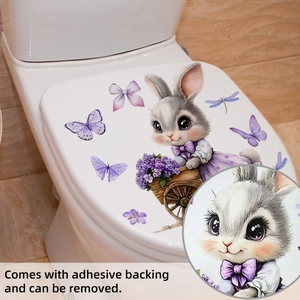 Détail d'un autocollant lapin et fleurs montrant l'adhésif amovible sur l'abattant WC