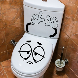Grappige cartoon gezicht en handen stickers op een wit keramisch toilet