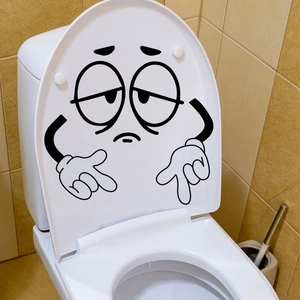 Grappige vintage cartoon gezicht sticker op een wit keramisch toiletdeksel