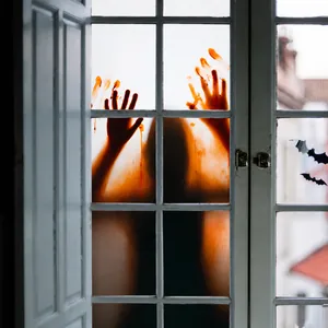 Detail of Halloween window cling showing bloody handprints and scary ghost silhouette