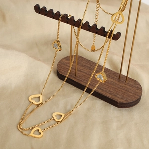 Double-layered gold box chain necklace with hollow and diamond-studded heart pendants