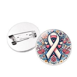 Pink ribbon awareness brooch with colorful floral patterns and a secure metal pin back