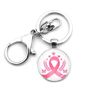 Close-up of pink ribbon breast cancer awareness keychain with silver metal heart and butterfly