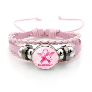 Detail of pink leather bracelet with breast cancer awareness pink ribbon charm