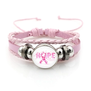 Pink breast cancer awareness leather bracelet with ribbon hope charm on white background