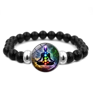 Detail of Yoga Chakra bead bracelet with black obsidian and nebula meditation charm