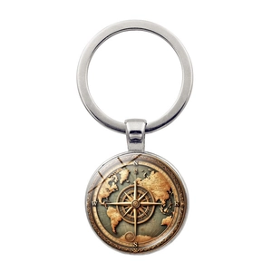 Macro detail of vintage world map and compass design under a glass dome key ring