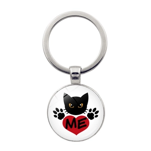 Close-up of black cat pendant with red heart and ME text on a metal keychain