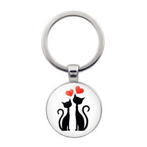 Round silver keychain with black cat silhouette and red heart time gem pendant design