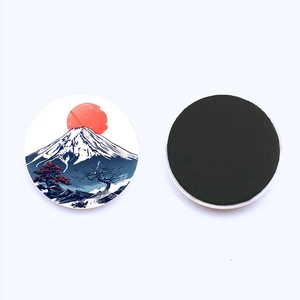 Detail of Mount Fuji fridge magnet showing front sunrise art and back magnetic surface