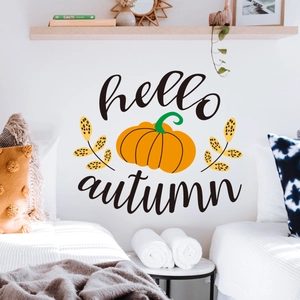 Detail of hello autumn pumpkin wall sticker on white wall in minimalist bedroom