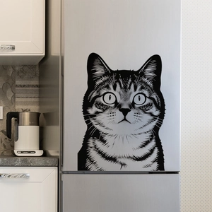 Close-up of a creative black and white cat wall sticker on a modern silver refrigerator