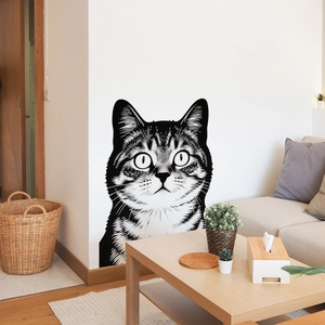 Close-up of artistic black and white cat head wall sticker on a modern living room wall