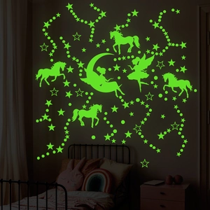 Glow in the dark unicorn and fairy wall stickers in a dark kids room nighttime setup