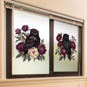 Detail of vintage owl and purple flower static window stickers on home glass pane