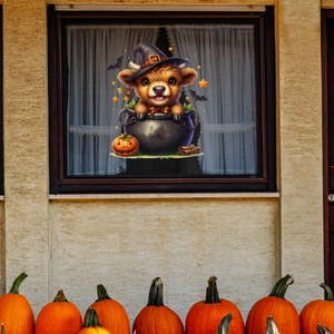 Detail of Halloween window cling featuring a highland cow in a cauldron with pumpkins