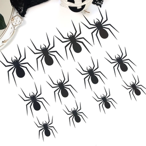 Detail of multi-size black 3D spider wall stickers for Halloween party room decoration