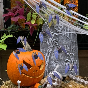 Detail of cute purple and black cartoon bats set in a festive Halloween scene