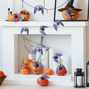 Macro view of purple and black bat stickers on a decorated fireplace for Halloween