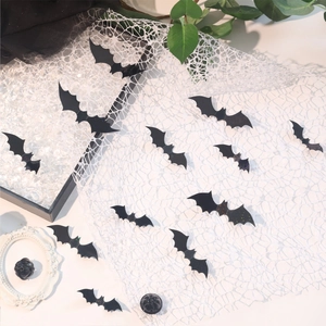 3D black bat wall stickers for Halloween decor shown on a vintage white lace fabric