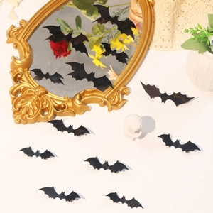 3D black bat wall stickers in various sizes for Halloween decor on a mirror and white table