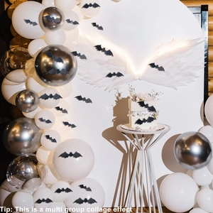 Detailed view of Halloween party set with 3D black bats and white balloon arrangement