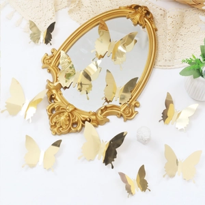 Detailed view of 3D metallic gold butterfly stickers on vintage mirror with various sizes