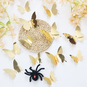 Macro shot of 3D gold mirror butterfly stickers with reflective finish on a bright background
