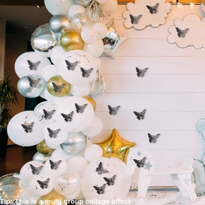 Detailed view of black laser-cut butterfly stickers used for party balloon decoration