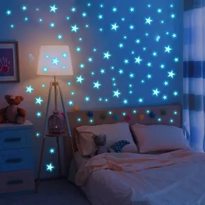 Luminous glow-in-the-dark blue star wall stickers in a cozy night bedroom setting