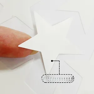 Detail of applying glow-in-the-dark star wall sticker showing material thickness and texture