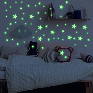 Luminous star wall decals glowing in a dark kids bedroom for starry ceiling decoration