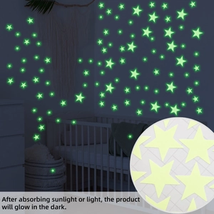 Glow in the dark star wall stickers showing luminous green effect in a dark nursery bedroom