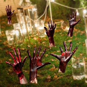 Realistic Halloween zombie hand stakes with blood splatters on lawn at night