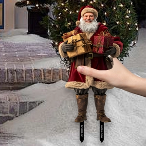 Detail of a Santa Claus garden stake holding gift boxes for Christmas yard decoration