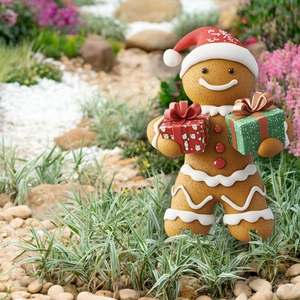 Creative gingerbread man garden stake decoration with Santa hat and Christmas gift boxes